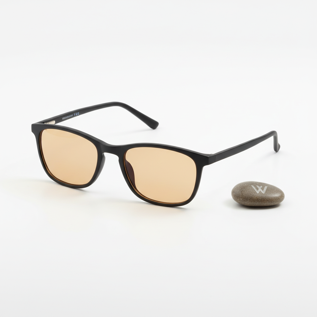 Nocturely Blue Light Blocking Glasses with amber-tinted lenses and matte black frame on a clean white surface